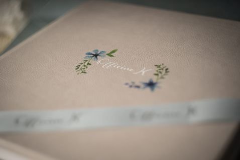 close up photo of a photo album cover for a baby boy baptism