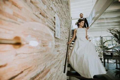 bride and groom walking down the stairs of their wedding venue