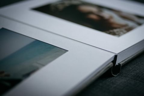 Open photography album with a blurred image of a lady on the page