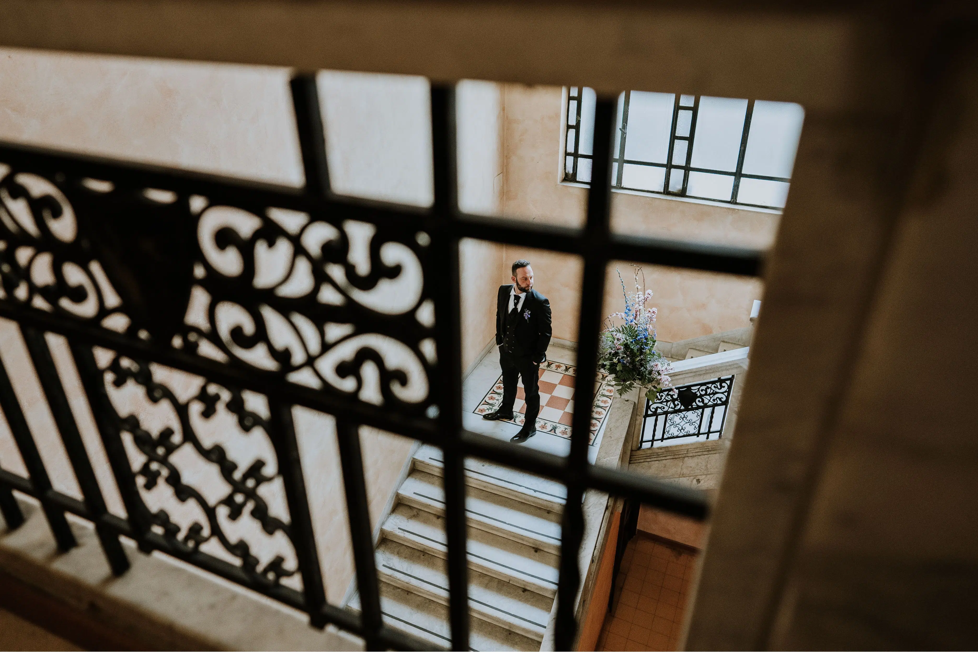 Groom on his wedding day at the stairs of the registry office